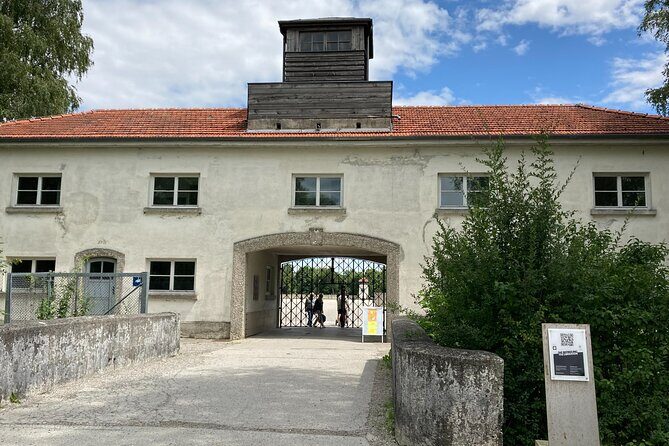 Dachau Concentration Camp Private Tour by Train from Munich - Walking the Memorial Site: Gatehouse, Bunker, Crematorium, and the Rail Platform